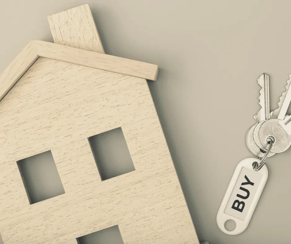 House keys next to a small wooden house